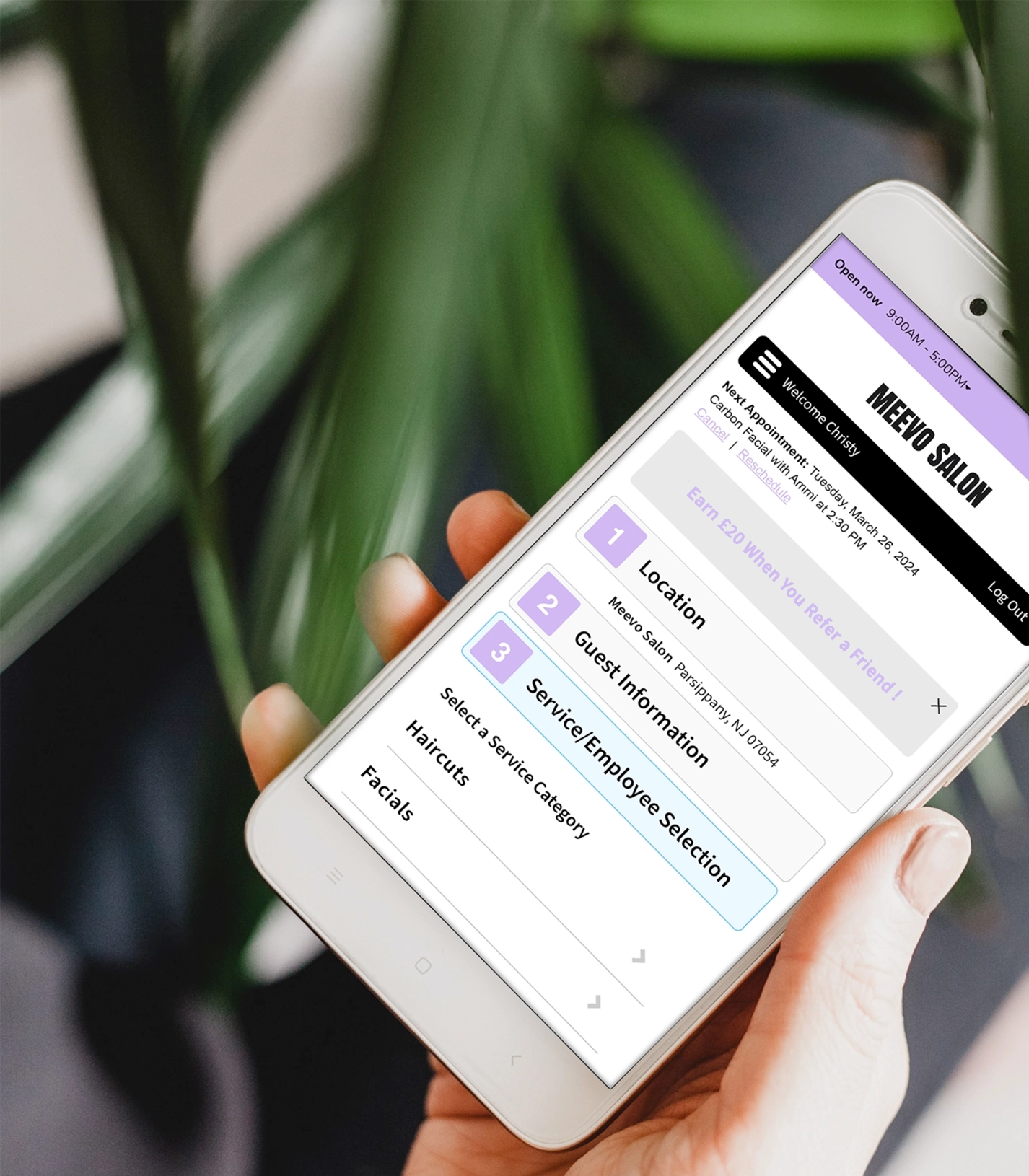 hand holding iphone to make an online appointment on Meevo